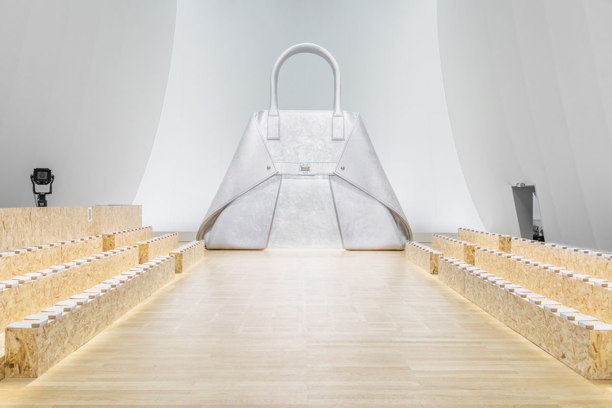 Runway set with a giant white handbag