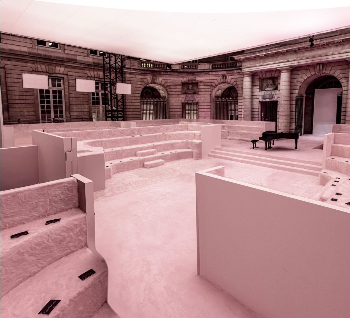 Pink show set in a courtyard