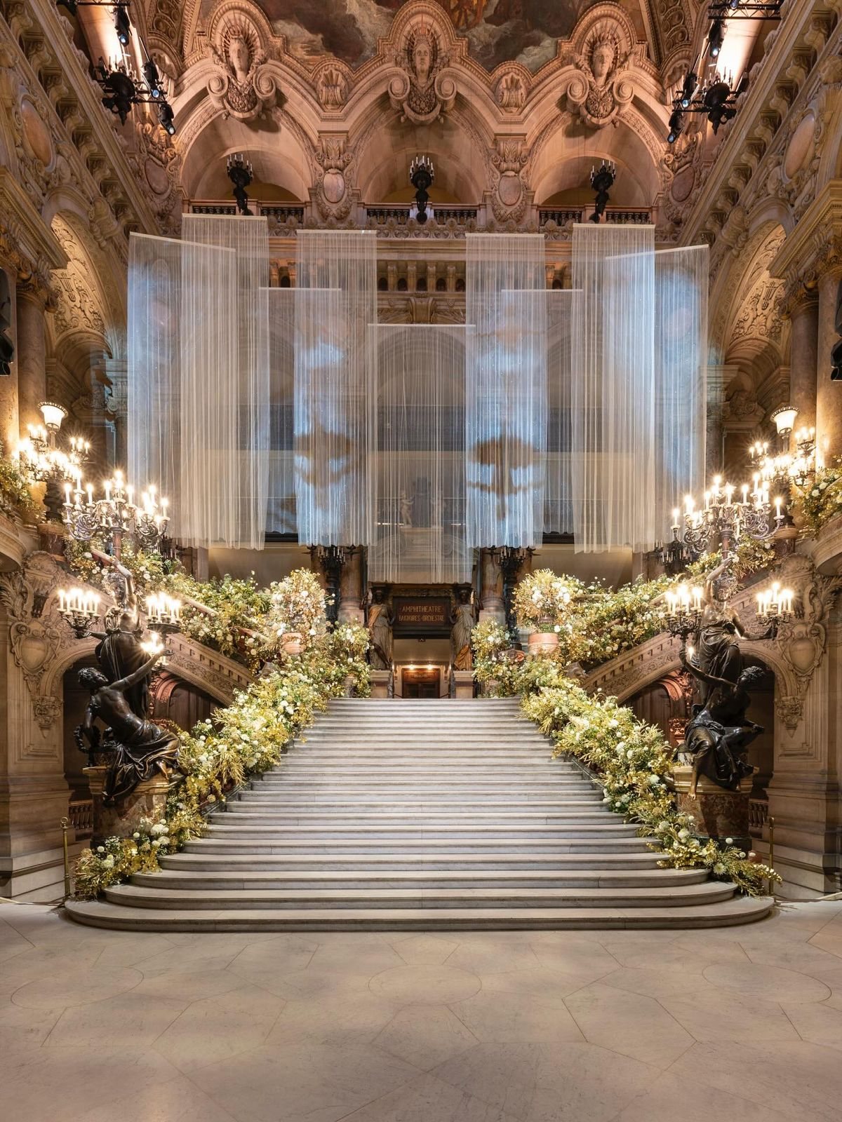 Grand staircase dressed with flowers and drapes